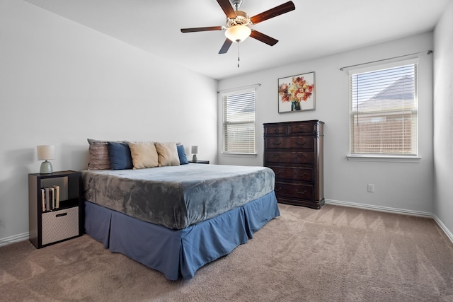 bedroom featuring ceiling fan, baseboards, and light colored carpet