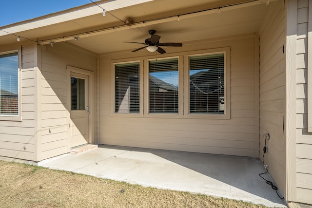 property entrance with a ceiling fan and a patio