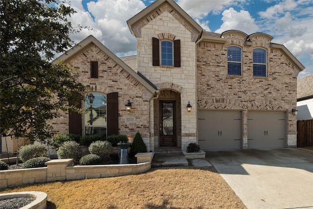 french country home featuring brick siding, a garage, and concrete driveway