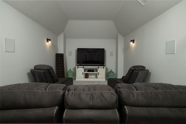 home theater room with visible vents and vaulted ceiling