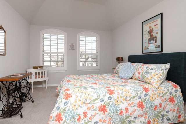 bedroom with baseboards, lofted ceiling, and light colored carpet