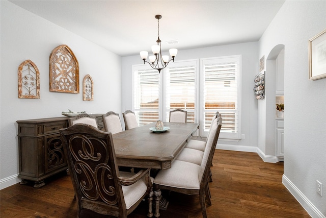 dining room with baseboards, dark wood-style flooring, a notable chandelier, and visible vents