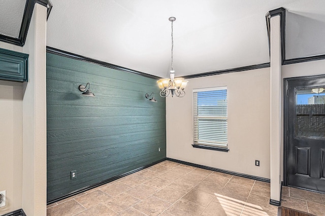 unfurnished dining area with a notable chandelier and baseboards