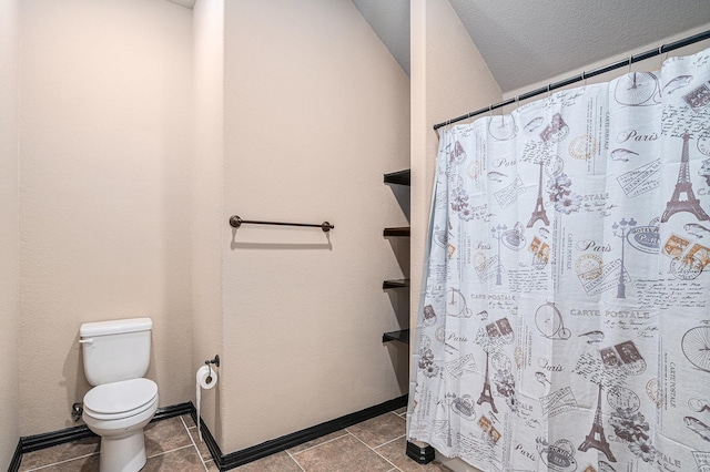 bathroom with toilet, a shower with shower curtain, baseboards, and tile patterned floors