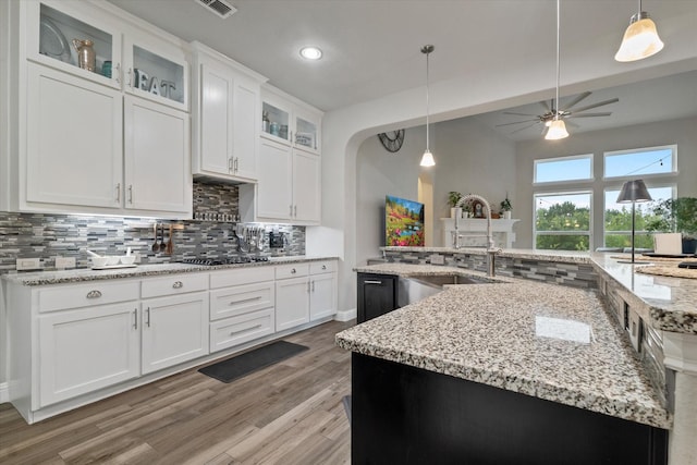4109 Chantilly Ln, Frisco, TX 75036 - kitchen with a sink, backsplash, a ceiling fan, white cabinetry, and light wood-style flooring