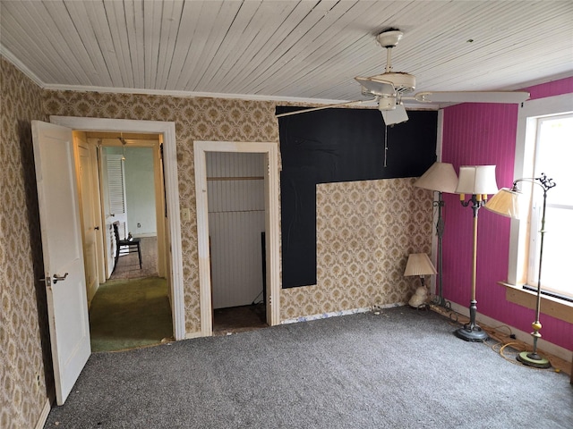 interior space with wallpapered walls, carpet floors, wooden ceiling, and crown molding