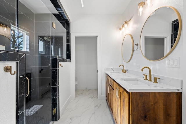 full bathroom featuring marble finish floor, a sink, a stall shower, and double vanity