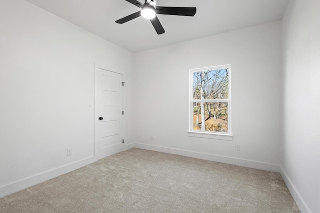 unfurnished room with ceiling fan, baseboards, and carpet