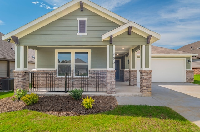 view of front of property with brick siding, concrete driveway, cooling unit, a porch, and an attached garage