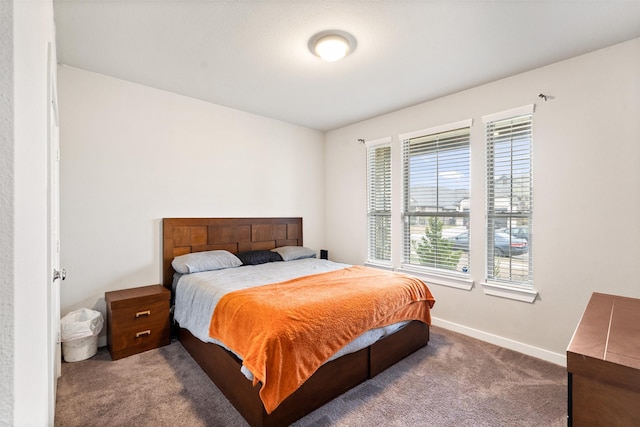 carpeted bedroom featuring baseboards