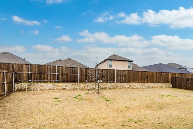 view of yard with a fenced backyard