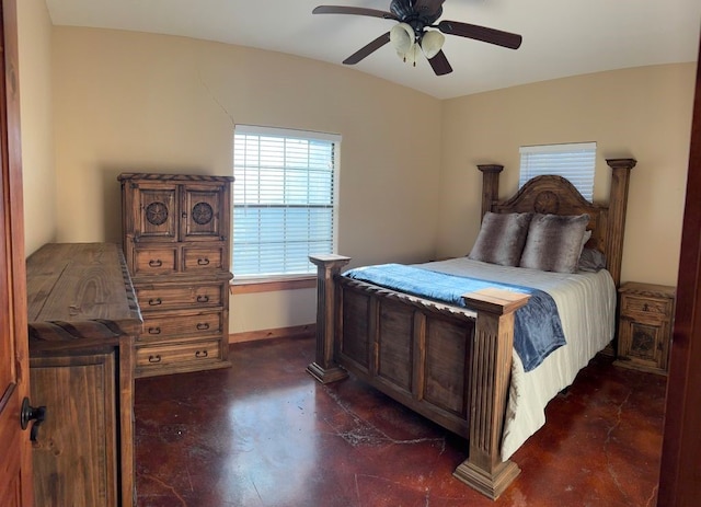 bedroom with finished concrete flooring, a ceiling fan, and baseboards