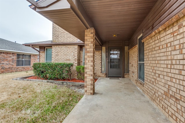 doorway to property featuring brick siding