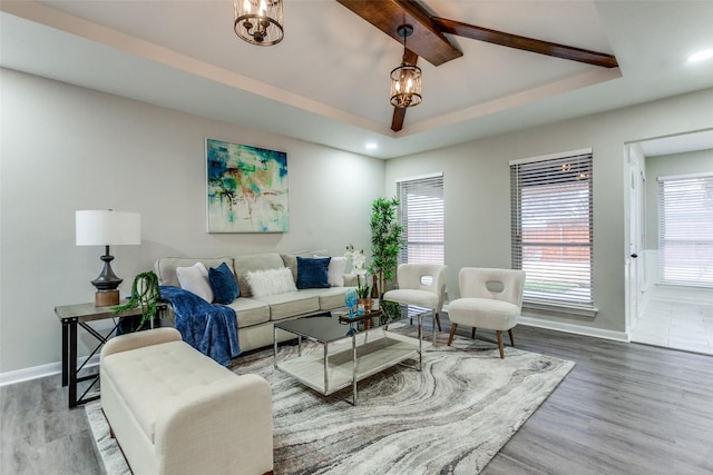 living area featuring baseboards, a wealth of natural light, and wood finished floors