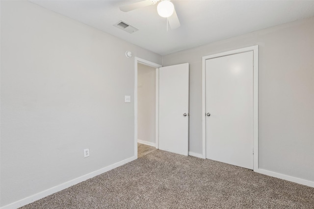 unfurnished bedroom with baseboards, ceiling fan, visible vents, and carpet