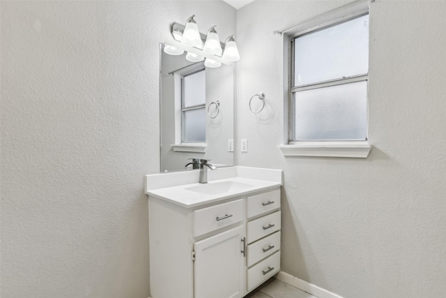 bathroom with vanity and a textured wall