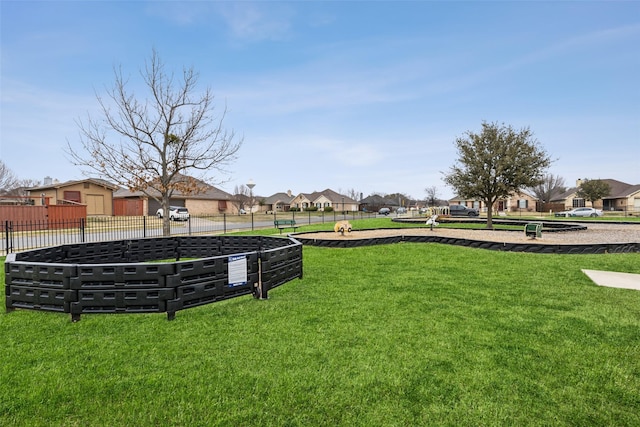 view of yard featuring fence and a residential view