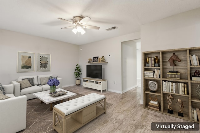 living room with baseboards, a ceiling fan, visible vents, and wood finished floors