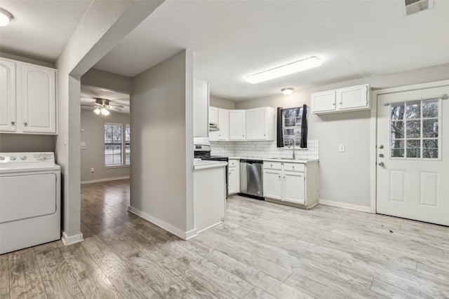 kitchen with white cabinetry, washer / dryer, appliances with stainless steel finishes, and light countertops