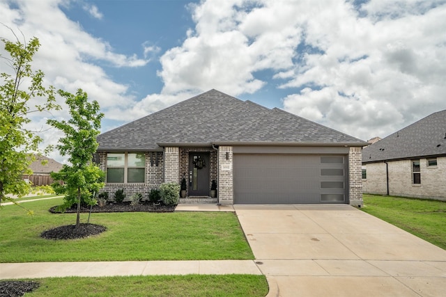 3002 Northshore Dr, Celina, TX 75009 - french country home with brick siding, a shingled roof, a garage, a front lawn, and driveway