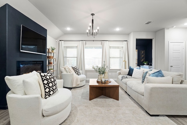3002 Northshore Dr, Celina, TX 75009 - living area with wood finished floors, a glass covered fireplace, a chandelier, recessed lighting, and lofted ceiling
