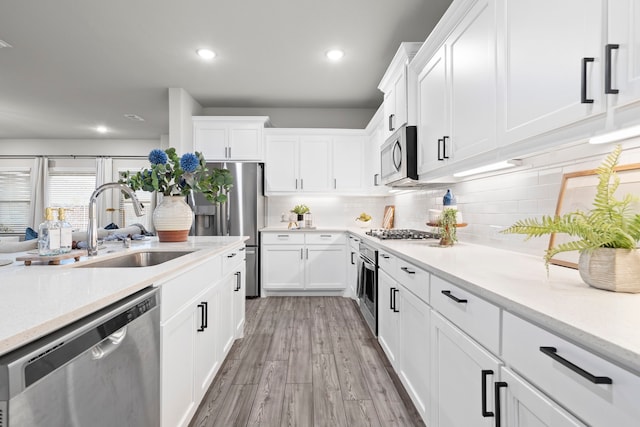 3002 Northshore Dr, Celina, TX 75009 - kitchen with appliances with stainless steel finishes, decorative backsplash, white cabinetry, and recessed lighting