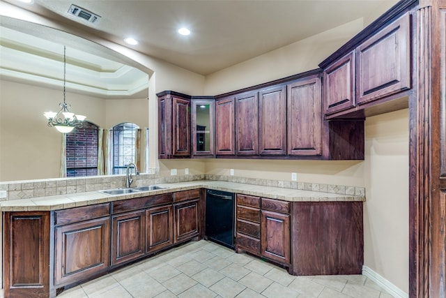 kitchen with visible vents, dishwasher, hanging light fixtures, light countertops, and a sink