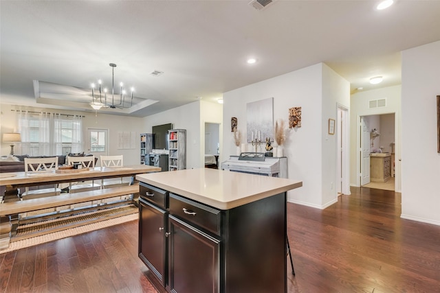 124 Feverbush Dr, Fate, TX 75189 - kitchen with dark wood-type flooring, open floor plan, light countertops, a kitchen island, and recessed lighting