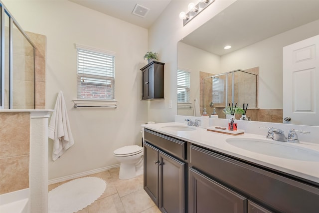 124 Feverbush Dr, Fate, TX 75189 - full bathroom with a tile shower, double vanity, toilet, tile patterned floors, and baseboards