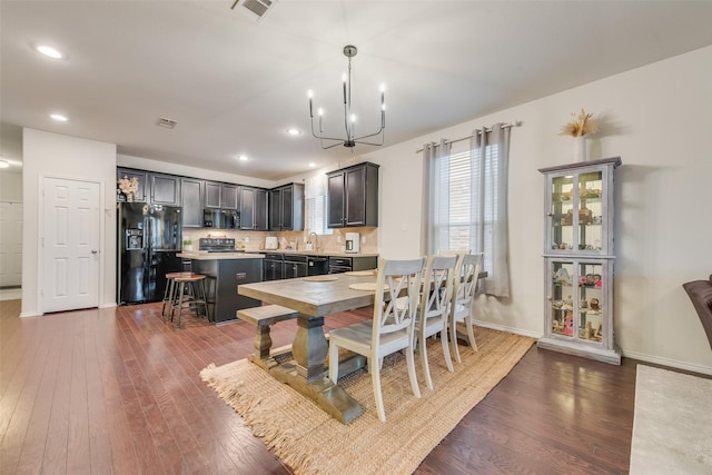 124 Feverbush Dr, Fate, TX 75189 - dining room with dark wood-style floors, a chandelier, baseboards, and recessed lighting