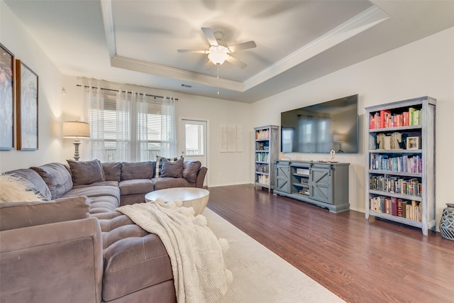 124 Feverbush Dr, Fate, TX 75189 - living area with a raised ceiling, ornamental molding, dark wood-style floors, a ceiling fan, and baseboards