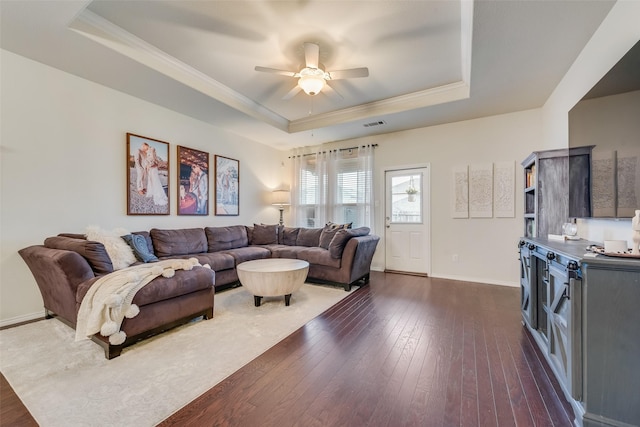 124 Feverbush Dr, Fate, TX 75189 - living room with a raised ceiling, dark wood-style flooring, ceiling fan, ornamental molding, and baseboards