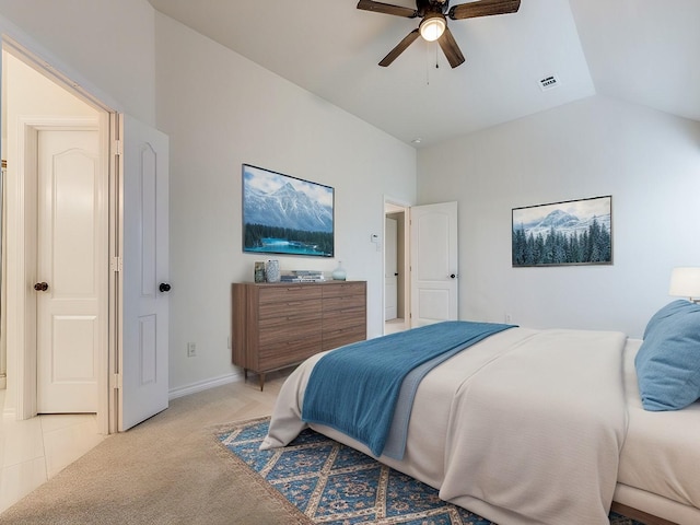 bedroom with visible vents, light carpet, vaulted ceiling, ceiling fan, and baseboards