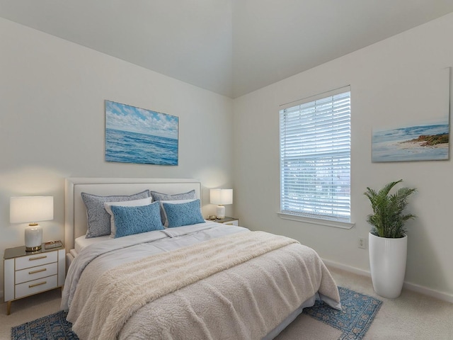 bedroom with light carpet and baseboards