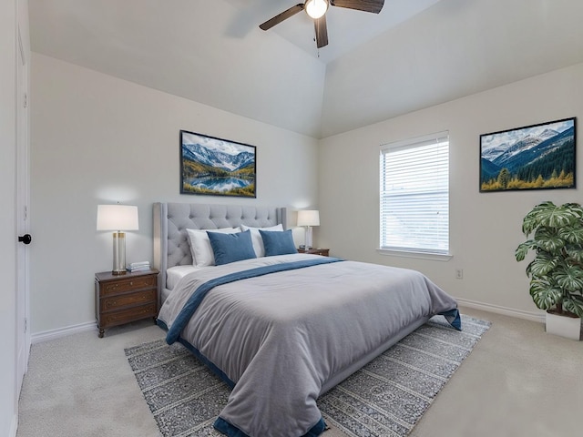 bedroom featuring light colored carpet, vaulted ceiling, baseboards, and ceiling fan