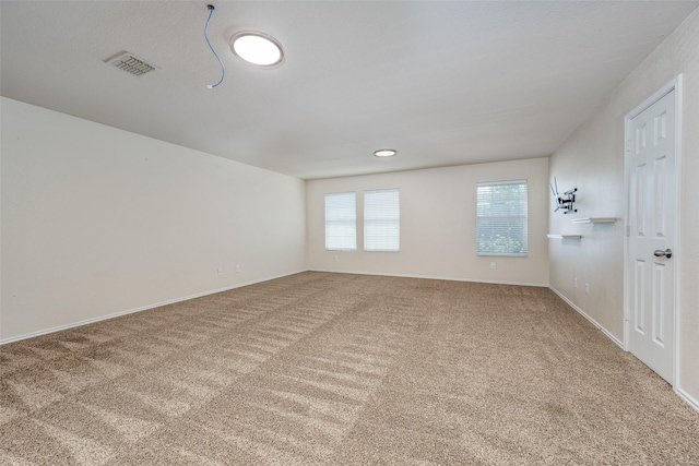 carpeted empty room with baseboards and visible vents