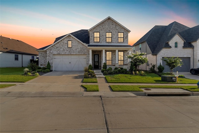 view of front of home featuring driveway, a porch, a lawn, and brick siding