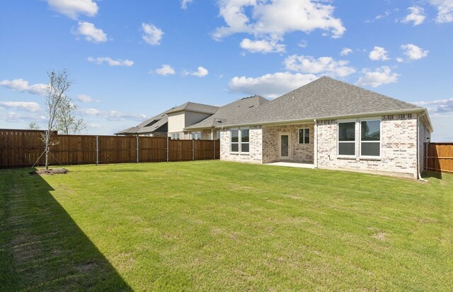 5917 Mayer Ave, Pilot Point, TX 75009 - back of property featuring roof with shingles, brick siding, and a patio