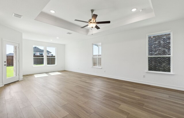 5917 Mayer Ave, Pilot Point, TX 75009 - spare room with a raised ceiling, wood finished floors, a ceiling fan, recessed lighting, and baseboards