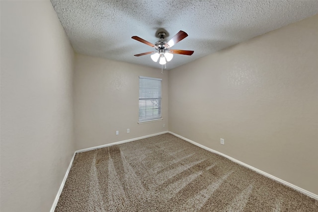 carpeted empty room featuring a ceiling fan, baseboards, and a textured ceiling