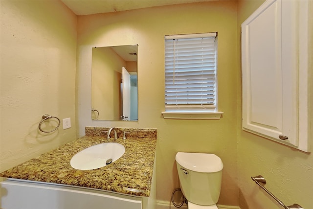 bathroom featuring toilet and vanity