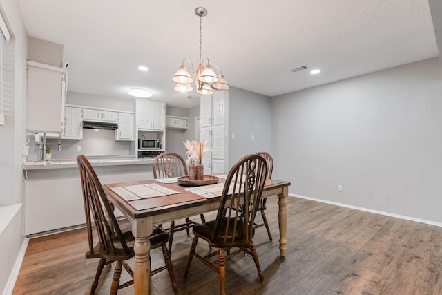 dining area with baseboards, visible vents, recessed lighting, and wood finished floors