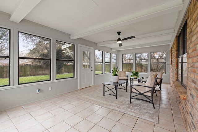 unfurnished sunroom featuring ceiling fan and beamed ceiling