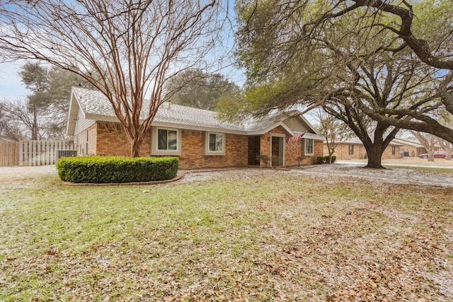 ranch-style home featuring fence, a front lawn, central AC, and brick siding