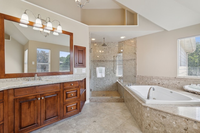 bathroom featuring a shower stall, a notable chandelier, a tub with jets, and a wealth of natural light