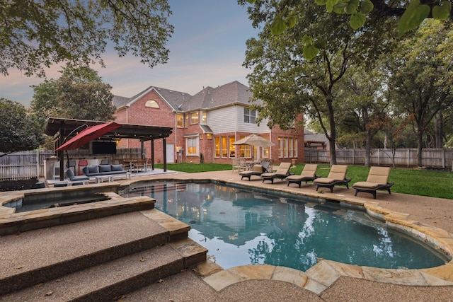 view of swimming pool with a fenced backyard, a fenced in pool, an outdoor hangout area, an in ground hot tub, and a patio area