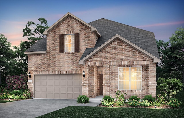 view of front of home with driveway, brick siding, and an attached garage