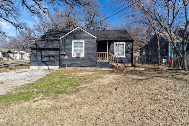 view of front of home featuring roof with shingles and cooling unit