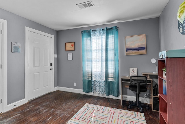 office area with baseboards, visible vents, and dark wood-style floors