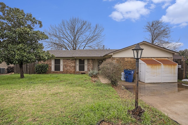 single story home with cooling unit, stone siding, concrete driveway, and a front yard